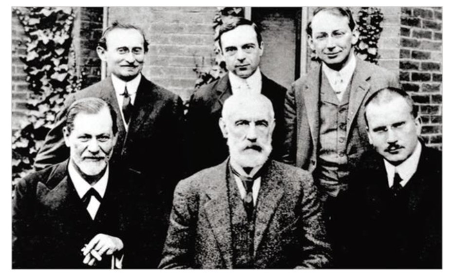 Fig.2. Six great psychoanalysts on a meeting in Worcester (USA) in 1909 at the Clark University. Left to right standing: Abraham Brill, Ernest Jones and Sándor Ferenczi. Left to right sitting: Sigmund Freud, Stanley Hall and Carl Gustav Jung. Both Freud and Jung received there a doctorate honoris causa. Freud gave 5 lectures in German the only time he was in the United States. The photo illustrates the multiple versions of psychoanalysis.