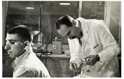 Fig. 3. Neuroscientist Eugene Aserinsky (right) attaches electrodes to his son, Armond, who was a frequent subject in Eugene s early sleep studies.
